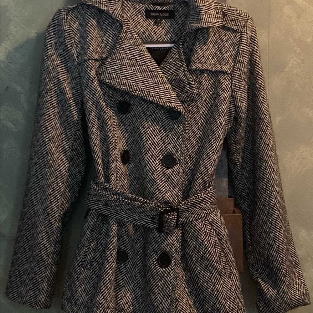 Double breasted jacket with belt and a notched collar, size medium.